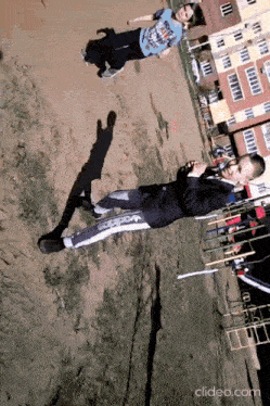 a boy and a girl are playing in the dirt and the girl is wearing a shirt that says ' avengers '