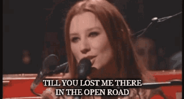 a woman singing into a microphone with the words " till you lost me there in the open road " below her