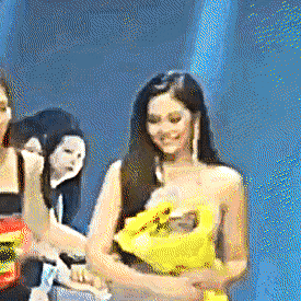 a woman in a yellow dress is standing next to a woman in a black dress