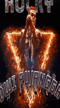 a man singing into a microphone in front of a fire triangle with the words " jui puangka " written on it