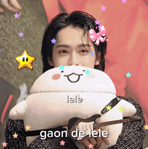 a person holding a stuffed animal with the word lele written on it