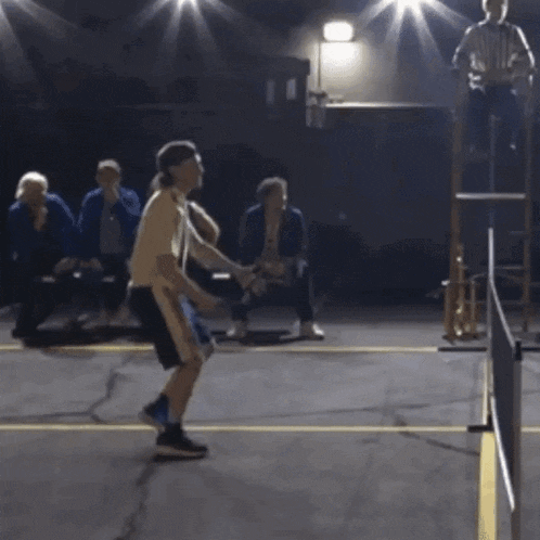 a group of people are playing a game of basketball