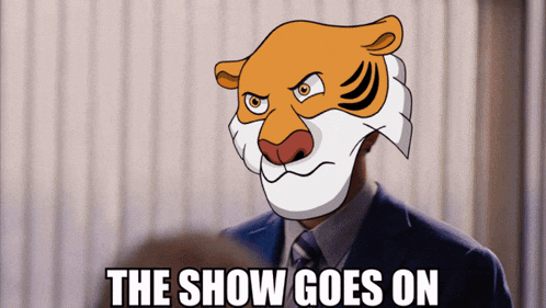 a man in a suit and tie with a tiger mask on his face and the words the show goes on