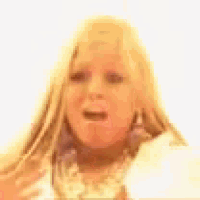 a close up of a woman 's face with long blonde hair making a funny face .