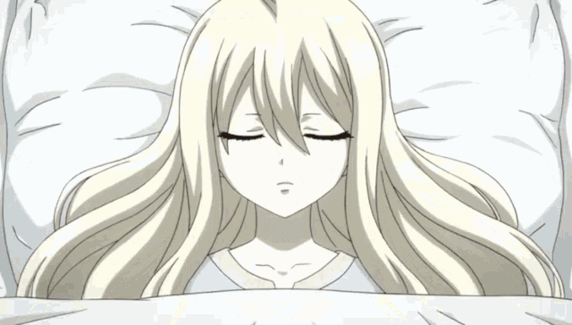 a blonde anime girl is laying on a bed with her eyes closed
