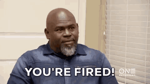 a man is sitting in front of a window and saying `` you 're fired '' .