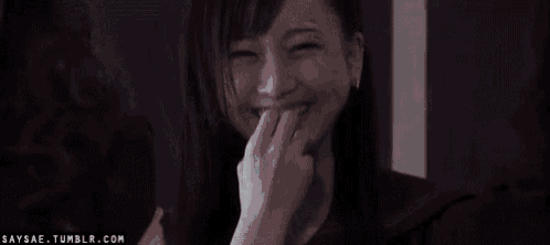 a close up of a woman 's face with a smile on her face .