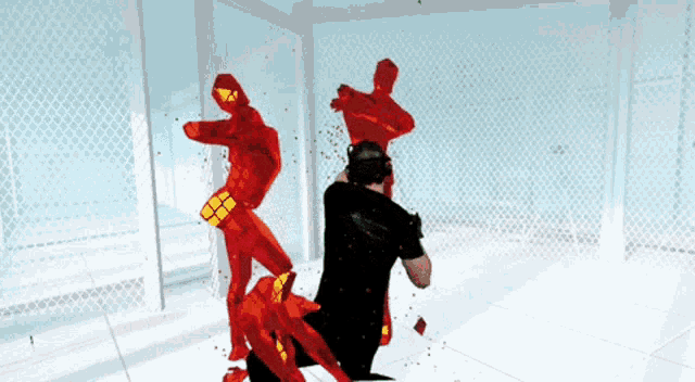 a man in a black shirt is being attacked by red silhouettes in a room