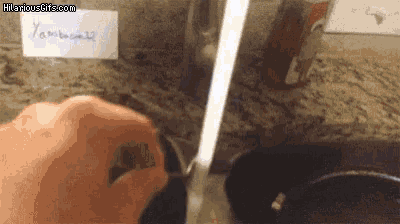 a hand is holding a knife in front of a sign that says " yamboo22 "