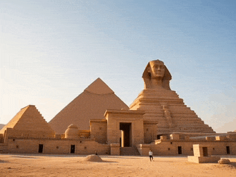 a man stands in front of a pyramid and a sphinx
