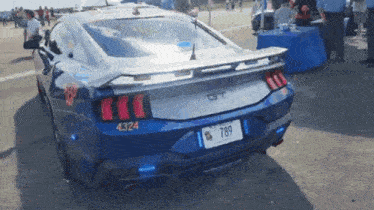 a blue ford mustang with a license plate that says 789