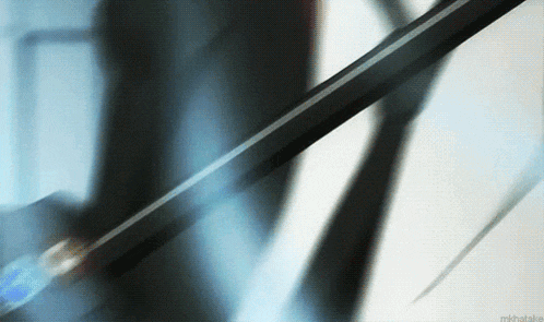 a blurry picture of a person holding a sword with the word mikhail on it
