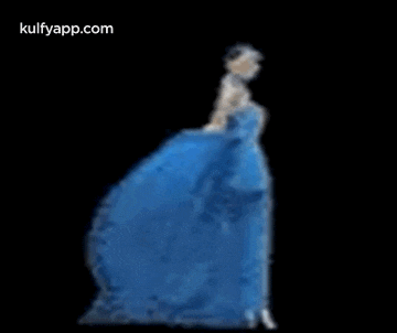 a woman in a blue dress is dancing on a stage .
