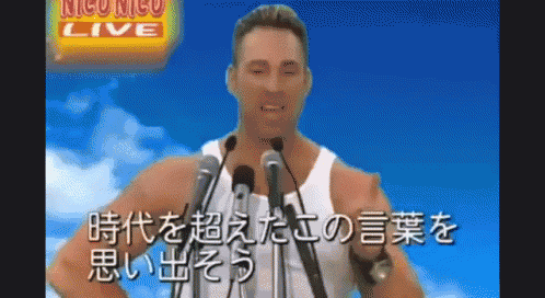 a man is giving a speech in front of microphones with a sign that says niconico live