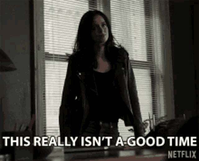 a woman standing in front of a window with the words " this really isn 't a good time " on the bottom