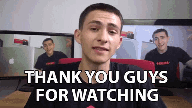 a man says " thank you guys for watching " in front of two computer monitors