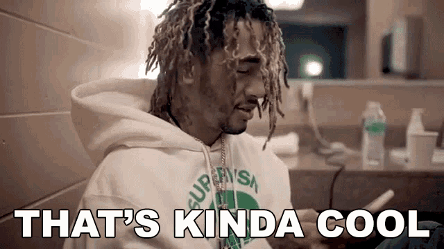 a man with dreadlocks is wearing a white hoodie that says that 's kinda cool .