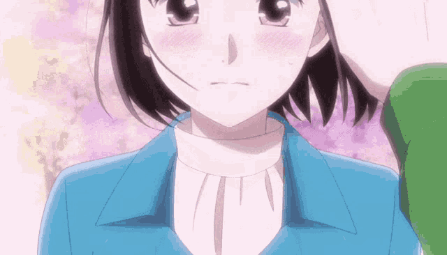 a close up of a person 's face with a girl in a blue shirt .