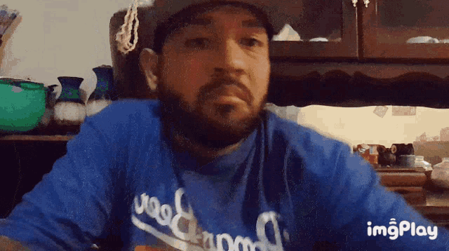 a man with a beard wears a dodgers shirt