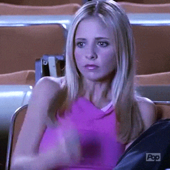 a woman in a pink tank top is sitting in a chair in a stadium .