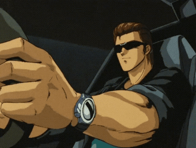 a man wearing sunglasses and a watch holds the steering wheel