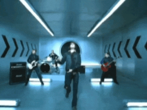 a group of men are playing instruments in a room with arrows on the walls