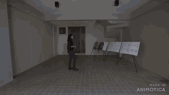 a woman opens a door next to a sign that says made in animonica