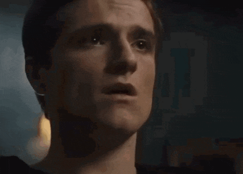 a close up of a man 's face with his mouth open and a surprised look on his face .