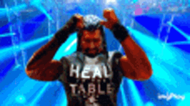 a man wearing a black shirt that says real table