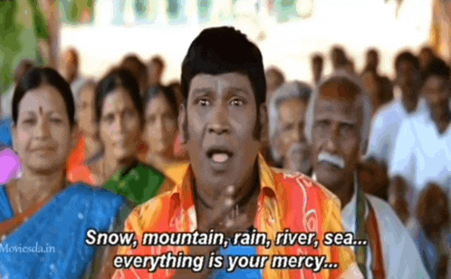 a man is standing in front of a crowd of people and saying snow , mountain , rain , river , sea