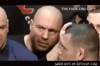 a group of men are standing around a man 's head and talking to him .