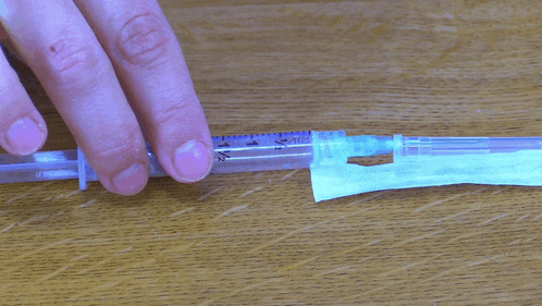 a person is holding a syringe with a needle that says 1/2
