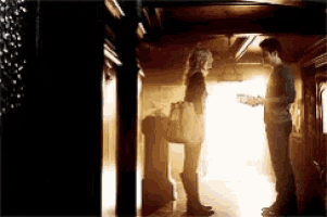 a man and a woman standing next to each other in a hallway .
