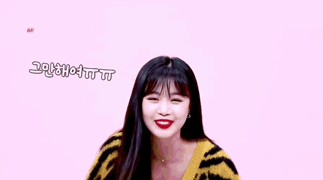 a woman in a tiger print sweater is smiling while holding a red brush .