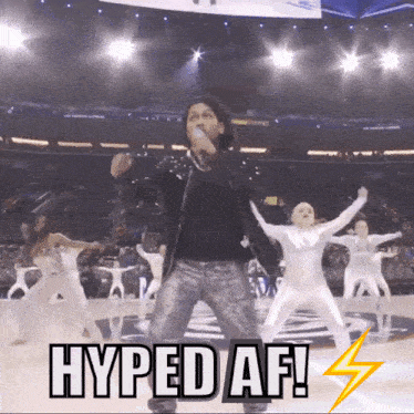 a man singing in front of a crowd with the words hyped af
