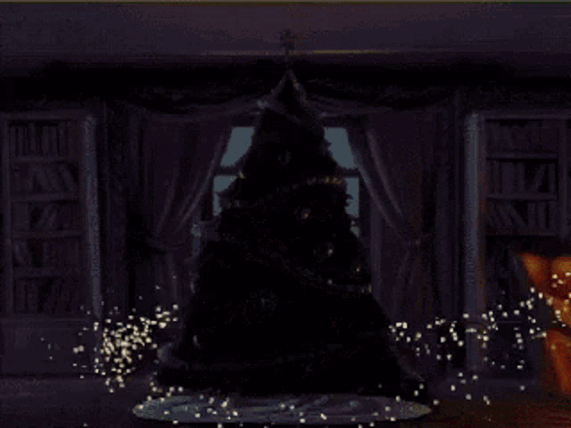 a christmas tree with a star on top is in a living room