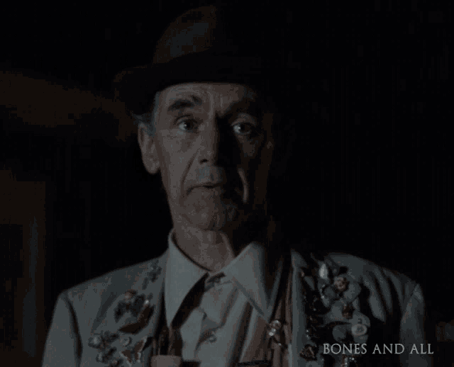 a man wearing a hat and badges is featured in a bones and all ad