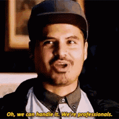 a man wearing a hat and a shirt is talking and saying oh , we can handle it . we are professionals .