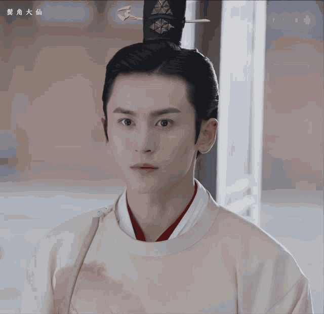 a man with chinese writing on the bottom right corner