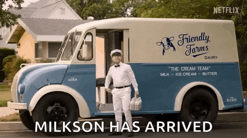 a man standing in front of a friendly farms dairy truck