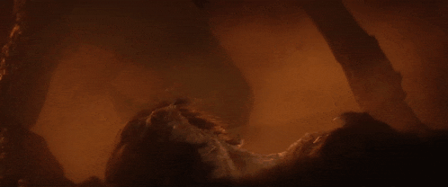 a close up of a person 's face in a dark room with a lot of smoke coming out of it .