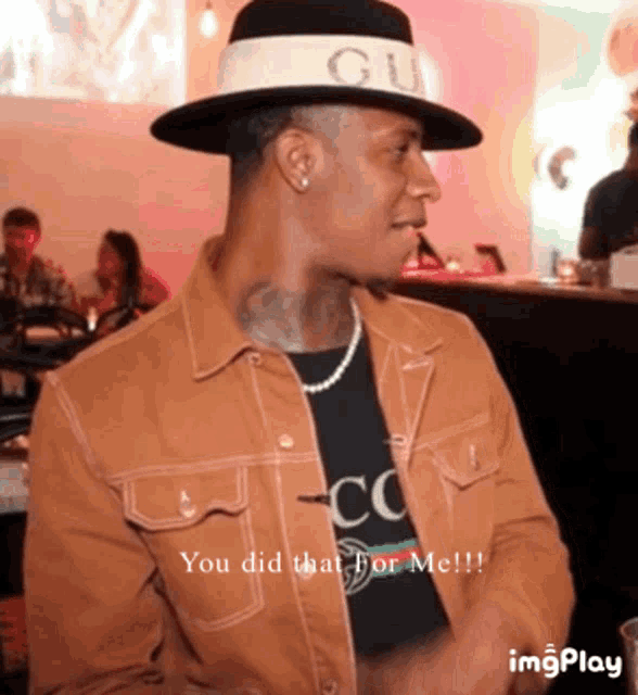 a man wearing a gucci hat and a gucci jacket says " you did that for me "