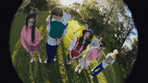 a group of people are posing for a picture in a park