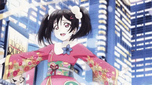 a girl in a pink kimono is standing in front of a tall building .