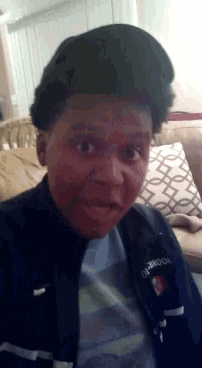 a young boy wearing a jacket that says reebok on it