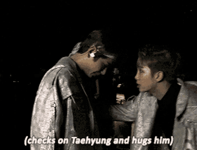 a man talking to another man with the words " checks on taehyung and hugs him "