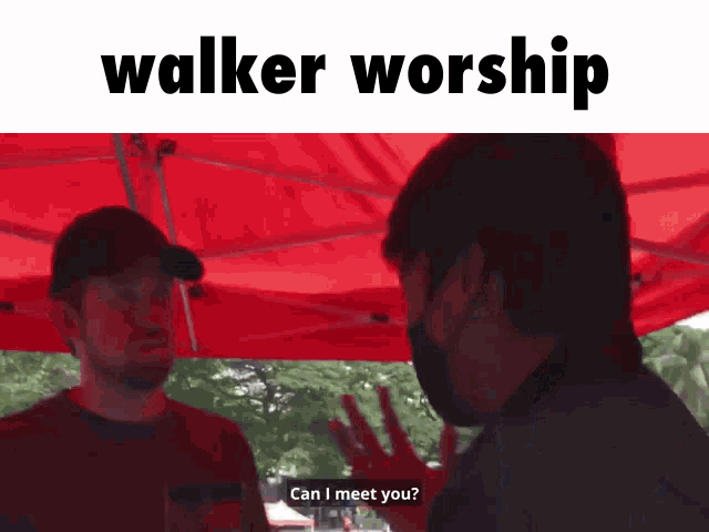 a man wearing a mask is talking to another man under a red tent with the words " walker worship " on the top