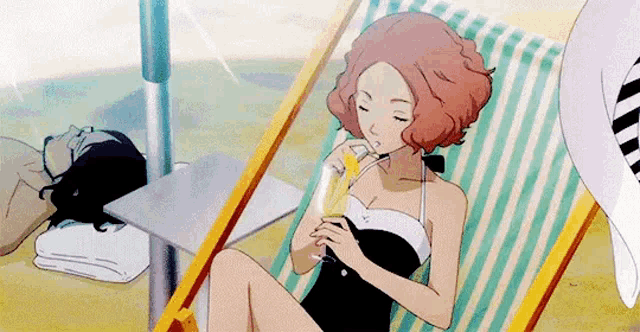 a woman in a swimsuit is sitting in a beach chair drinking from a glass .