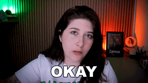 a woman is wearing a white shirt that says okay on it
