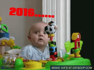 a baby is playing with a toy and the year 2016 is visible